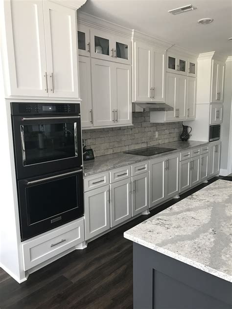 white shaker cabinets with black stainless steel appliances|black lower cabinets white upper.